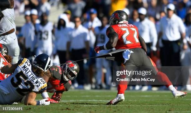 Clay Matthews of the Los Angeles Rams tries to make a shirt-tail tackle on Ronald Jones of the Tampa Bay Buccaneers in the second half at Los Angeles...