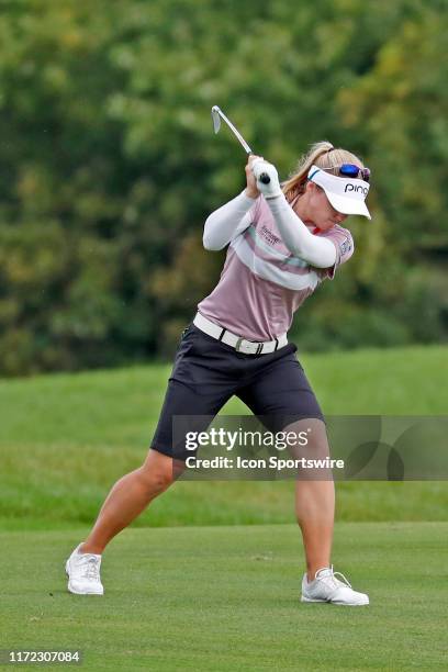 Golfer Brooke Henderson after hitting her second shot in a pot hole bunker slams her club into the turf in anger on the 8th hole during the final...