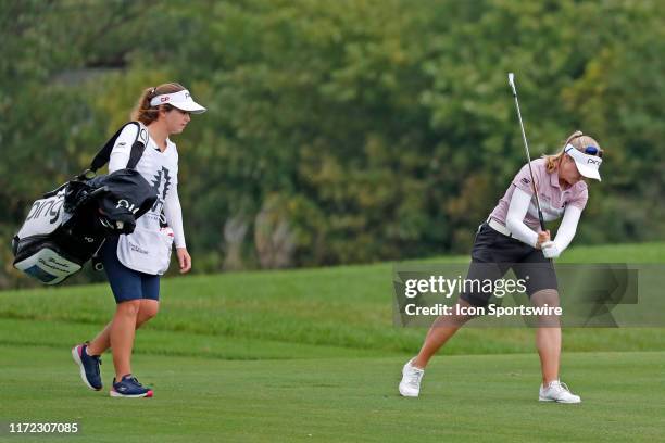 Golfer Brooke Henderson after hitting her second shot in a pot hole bunker slams her club into the turf in anger on the 8th hole during the final...
