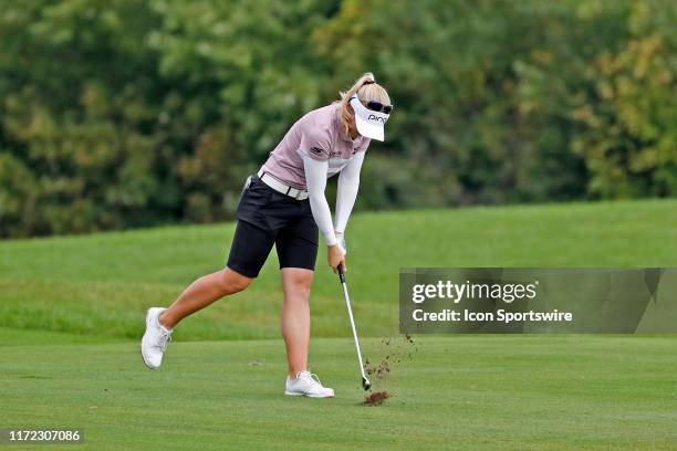 Golfer Brooke Henderson after hitting her second shot in a pot hole bunker slams her club into the turf in anger on the 8th hole during the final...