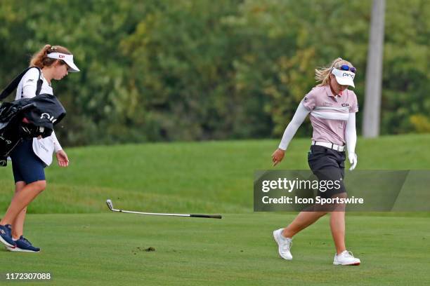 Golfer Brooke Henderson after hitting her second shot in a pot hole bunker gets upset and throws her club on the 8th hole during the final round of...