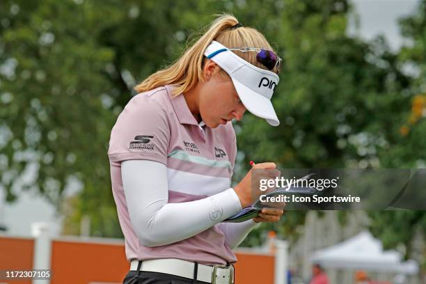 Golfer Brooke Henderson marks her scorecard while waiting on the 9th tee during the final round of the Indy Women In Tech on September 29 at the...