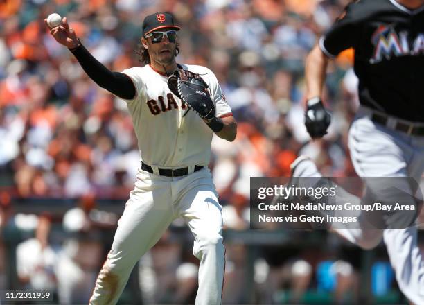 San Francisco Giants' Michael Morse throws to first base for an out on a bunt by Miami Marlins' starting pitcher Jacob Turner in the third inning at...