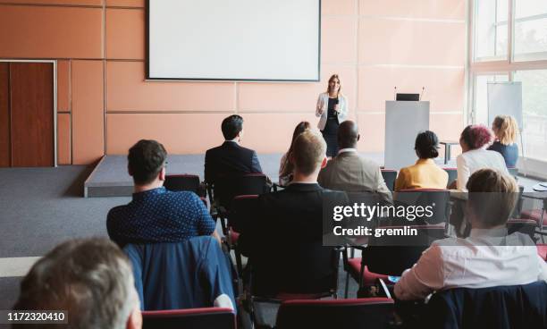 businesswoman lectures at business conference - conference stage stock pictures, royalty-free photos & images