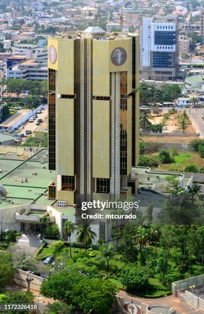 central bank of west african states - bceao tower, issues the west african cfa franc - bsic bank in the background, lomé, togo - central bank of west african states stock pictures, royalty-free photos & images