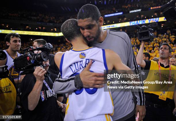 San Antonio Spurs' Tim Duncan hugs Golden State Warriors' Stephen Curry after Game 6 of the Western Conference semifinals at Oracle Arena on...