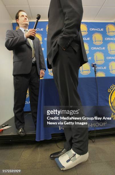 Golden State Warriors' new center Andrew Bogut, right, is interviewed during a press conference at Oracle Arena in Oakland, Calif. On Friday, March...