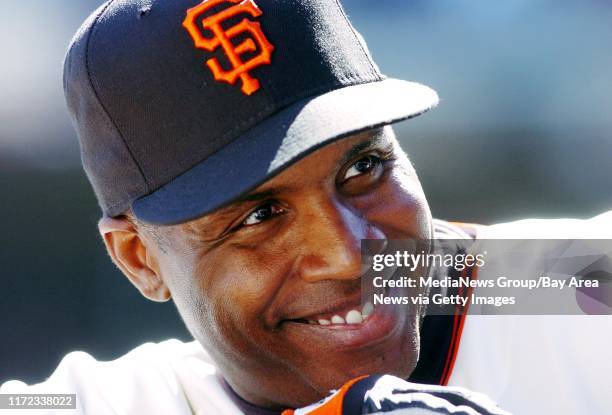 San Francisco Giants Barry Bonds, #25, lets out a big smile before being brought in to hit against the San Diego Padres in the 8th inning of their...