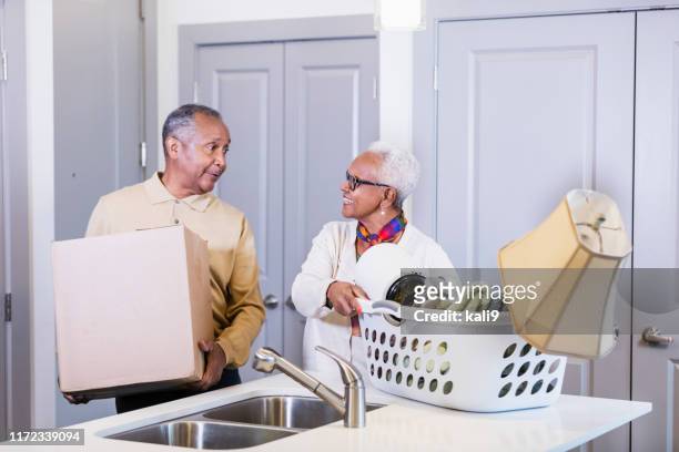 senior african-american couple moving house - senior moving house stock pictures, royalty-free photos & images