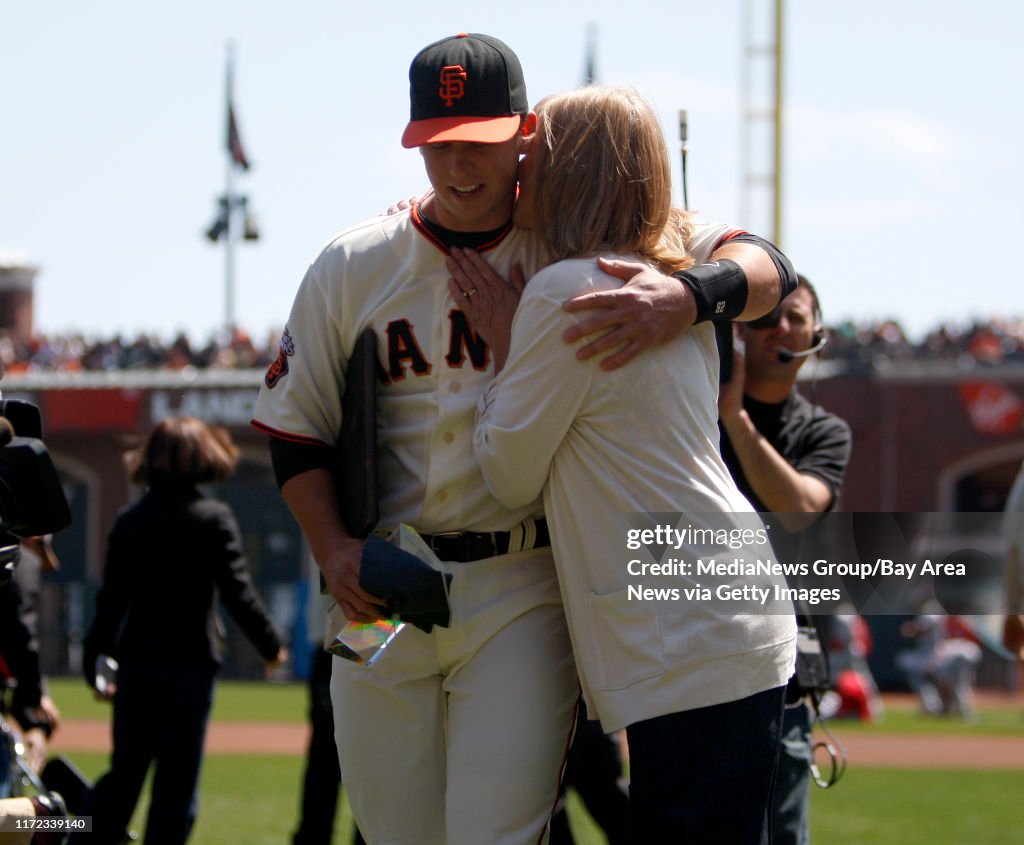 Buster Posey gets a hug from his mom Traci Posey after he was recognized as the 2010 NL Rookie of the Year Award and Players' Choice Award as the NL Outstanding Rookie as voted by players before their game against the St. Louis Cardinals at AT&T Park in S