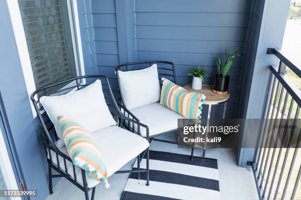 two chairs on a cozy balcony - patio furniture stock pictures, royalty-free photos & images