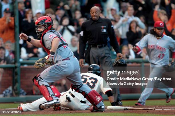 Cincinnati Reds' catcher Ryan Hanigan goes after the ball as San Francisco Giants' Melky Cabrera scores on Angel's Pagan's double in the second...