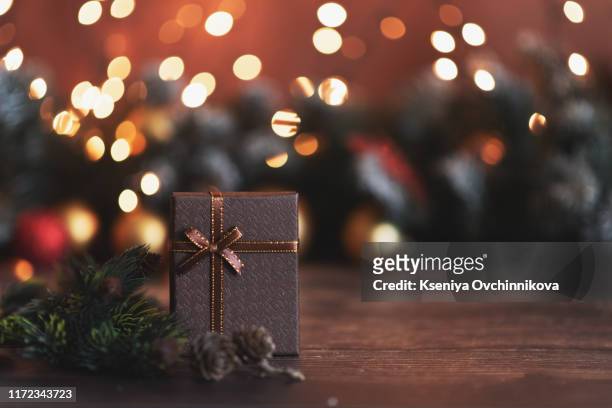 merry christmas and happy holidays a mother, father and their daughter prepare xmas gifts. baubles, presents, candy with christmas ornaments. top view. christmas family traditions. - happy holidays family stock pictures, royalty-free photos & images