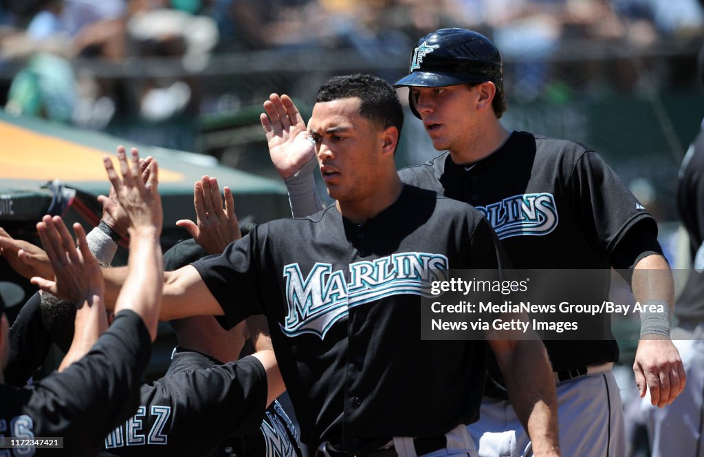Mike Stanton (l) and Logan Morrison of the Florida Marlins scored on a fifth inning two-run double by John Buck as the Florida Marlins continued their victorious ways, winning 5-4 Thursday June 30, 2011 at the O.co Coliseum in Oakland, Calif.  (Karl Mondo