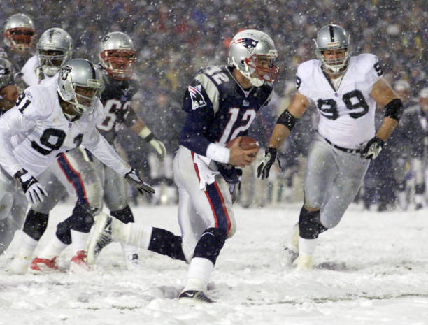 New England Patriots Tom Brady, #12, scrambles for a touchdown against the Oakland Raiders in the fourth quarter at Foxboro Stadium on Saturday,...