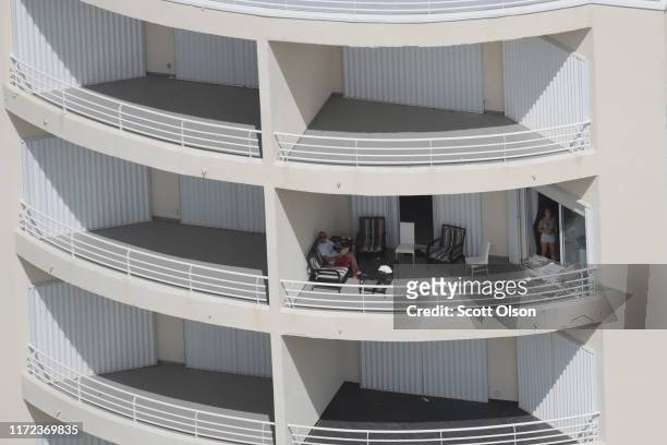 An aerial view of people sitting on their balcony following Hurricane Dorian on September 4, 2019 in Freeport, Bahamas. A massive rescue effort is...