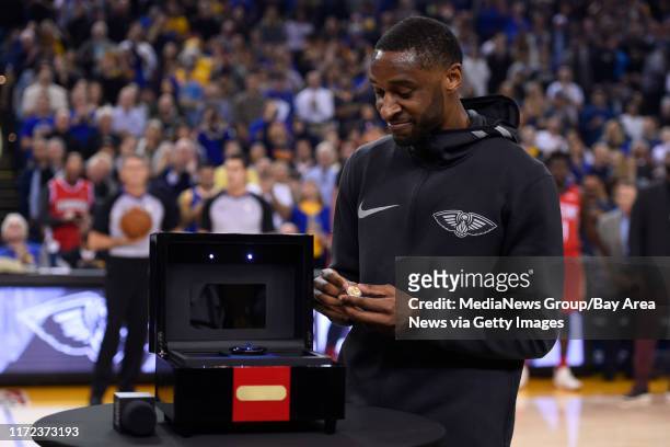 Former Golden State Warriors player Ian Clark, who now plays for the New Orleans Pelicans, receives his championship ring during a pregame ceremony...