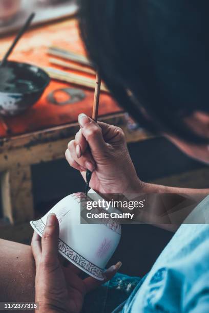 decorating a porcelain cup in a factory - chinese porcelain stock pictures, royalty-free photos & images