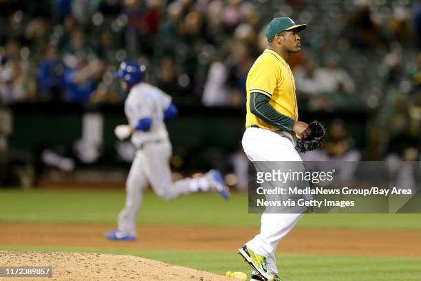 Oakland Athletics' Santiago Casilla reacts as Kansas City Royals' Drew Butera circles the bases after hitting his two-run home run in the eighth...