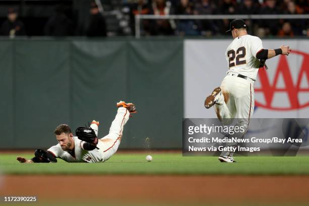 The San Francisco Giants' Christian Arroyo and Mac Williamson can't catch a base hit by the Los Angeles Dodgers' Justin Turner in the eighth inning...