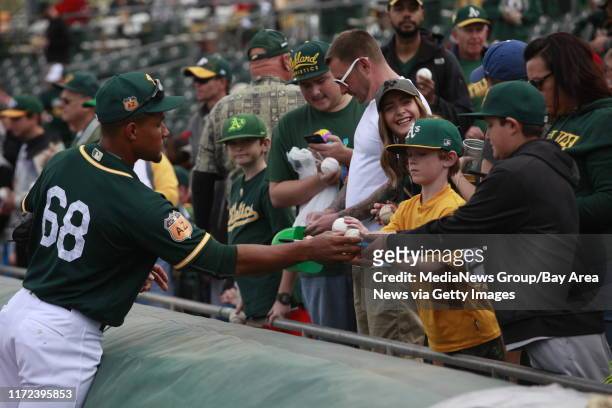 Oakland Athletics pitcher Richie Martin signs autographs for fans before the team's home opener in the Cactus League, Sunday, Feb. 26 at Hohokam Park...