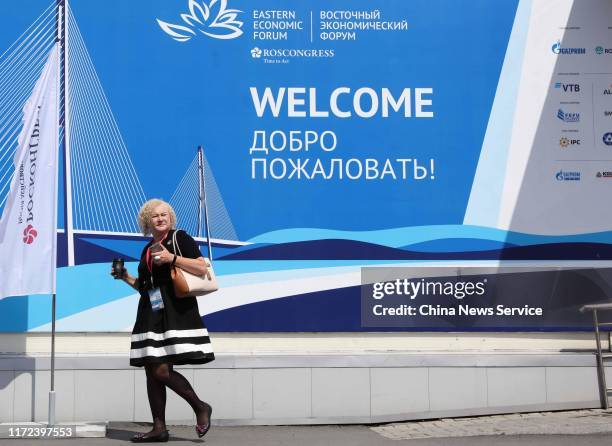 Woman walks by a welcome poster of the Eastern Economic Forum 2019 at Far Eastern Federal University on September 4, 2019 in Vladivostok, Russia. The...