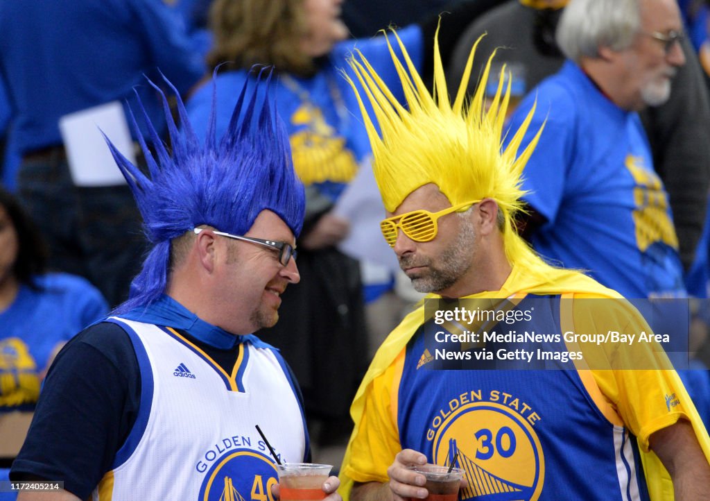 Warriors fans Luke Selway, left, and Curtis Schaper, both of San Jose, talk before the start of the Golden State Warriors game against the Memphis Grizzlies at Oracle Arena in Oakland, Calif., on Wednesday, April 13, 2016. The Warriors went on to win thei