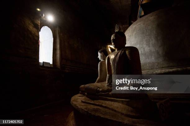 buddha statue with ancient pagoda in dambulla cave one of unesco world heritage site in sri lanka. - dambulla stock pictures, royalty-free photos & images