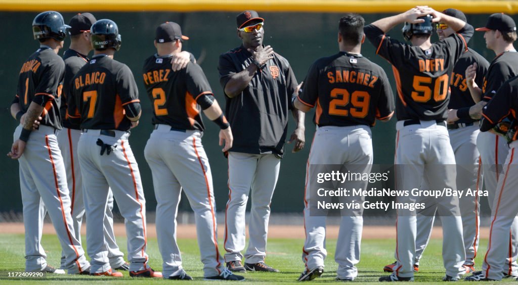 San Francisco Giants third base coach Roberto Kelly, center, talks to members of the team during spring training at Scottsdale Stadium in Scottsdale Ariz., on Thursday, Feb. 26, 2015. (Doug Duran/Bay Area News Group)