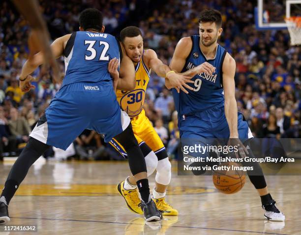 Golden State Warriors' Stephen Curry runs into Minnesota Timberwolves' Karl-Anthony Towns as he guards against Minnesota Timberwolves' Ricky Rubio in...