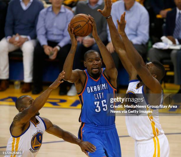 Oklahoma City Thunder's Kevin Durant passes against Golden State Warriors' Festus Ezeli in the second quarter of Game 1 of the NBA Western Conference...