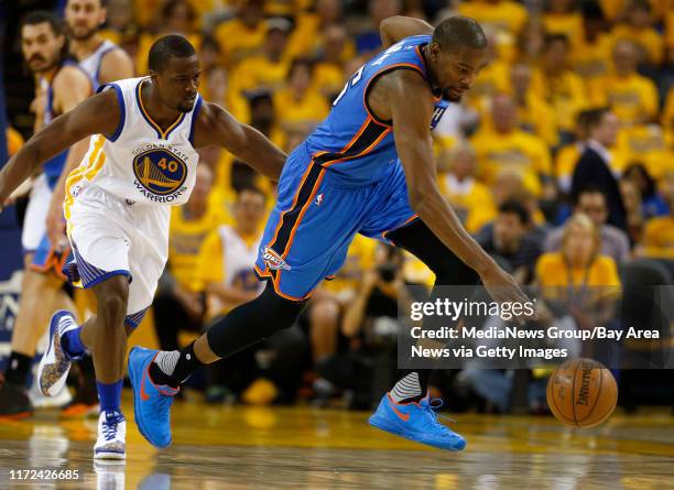 Oklahoma City Thunder's Kevin Durant heads down court after stealing the ball away from Golden State Warriors' Harrison Barnes in the third quarter...