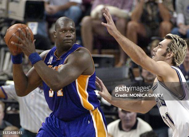 Shaquille O'Neal of the Los Angeles Lakers is guarded by Scot Pollard of the Sacramento Kings during the second quarter of game two of the NBA...