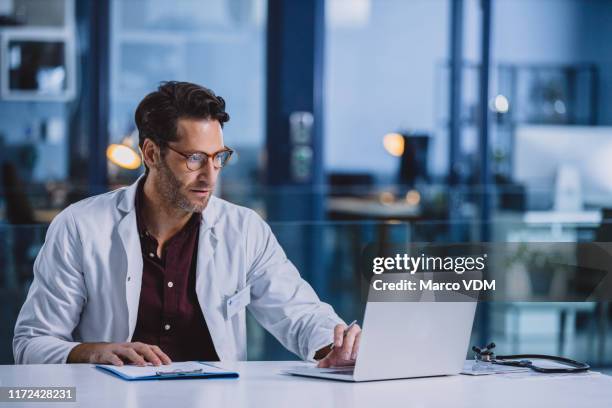 a doctor's work never ends - doctor male laptop stock pictures, royalty-free photos & images