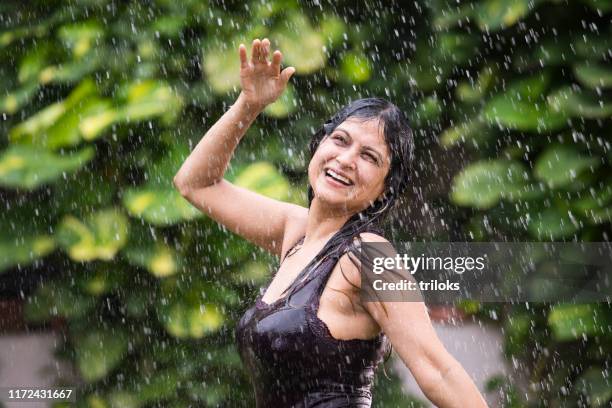 indian woman enjoying rain - india rain stock pictures, royalty-free photos & images