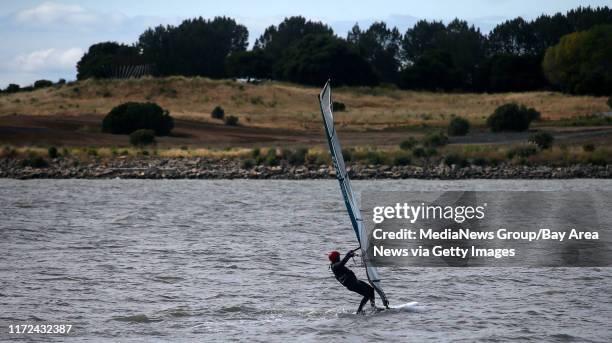 Windsurfer sails across the water on Monday, May 23, 2016 in San Leandro, Calif.