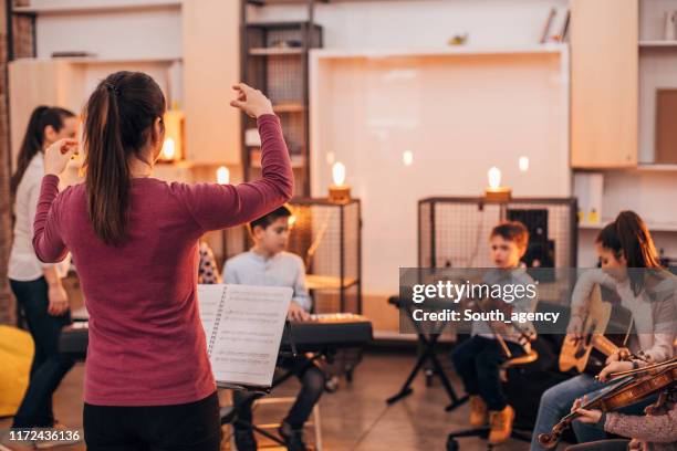 children orchestra in music school - classical music stock pictures, royalty-free photos & images
