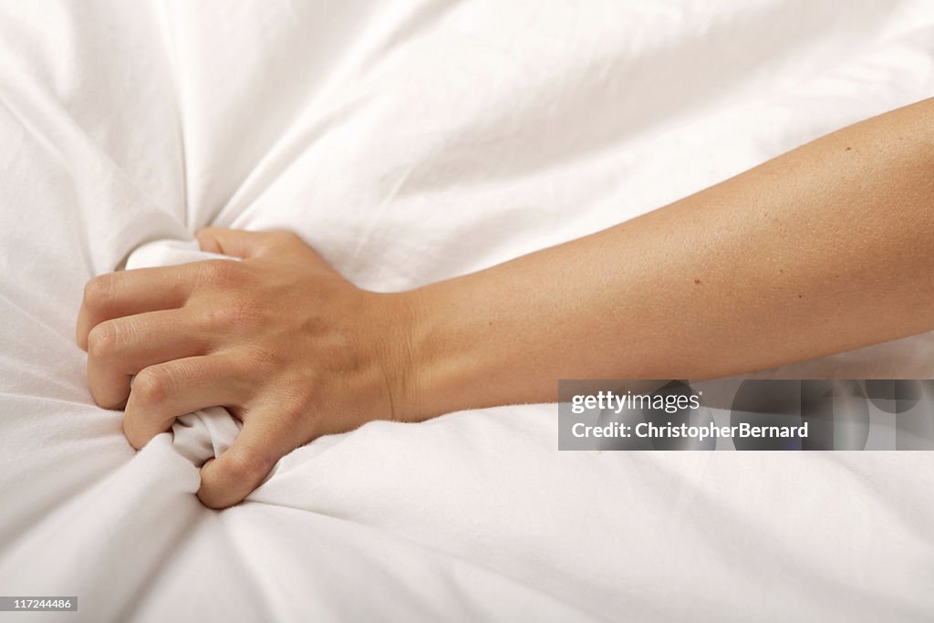 Hand grabbing sheet