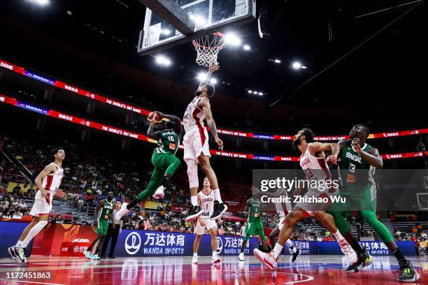 Lamine Sambe of Senegal drives and Khem Birch of Canada defends during the 2019 FIBA World Cup, first round match between Canada and Senegal at...