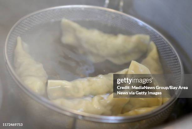 Ying Yang dumplings cook in the kitchen at Qi Dumpling Lounge in Oakland, Calif., on Tuesday, May 23, 2017.