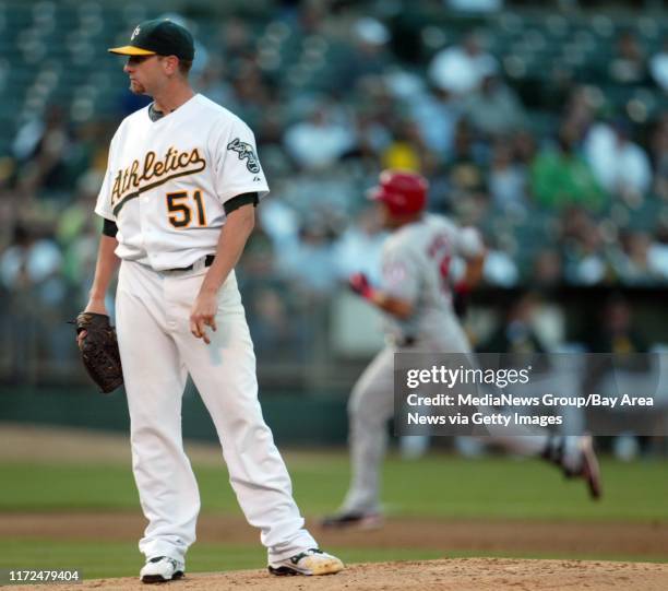 Oakland Athletics' starting pitcher Dallas Braden looks away as Los Angeles Angels' Kendry Morales runs the bases on his two-run homerun in the...