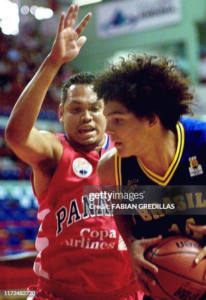 Anderson of Brazil protects the ball from Antonio Garcia of Panama during a second round game of the Pre-World Basketball Tournament in the Ruca-Che...