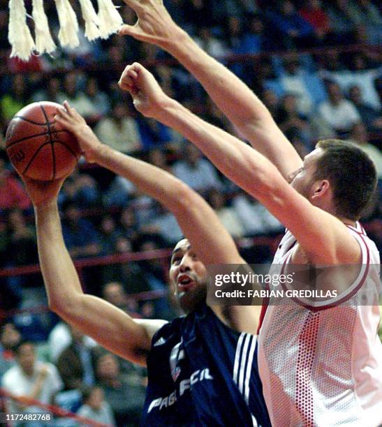 Emanuel Ginobili of Argentina triest to shoot the ball past Canada's Todd MacCulloch during a second-round game of the Pre-World Basketball...
