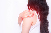The girl holds on to the shoulder in which the pain and inflammation, shoulder-shoulder periatritis, white background, close-up, copy space