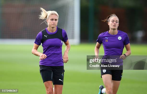 Steph Houghton and Tessa Wullaert of Manchester City Women warm up during a training session at Manchester City Football Academy on September 05,...