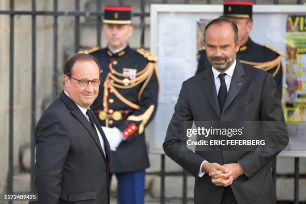 France's former President Francois Hollande is greeted by France's Prime Minister Edouard Philippe as he arrives to attend a church service for...