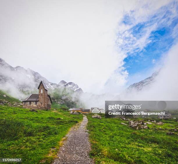 fog in the alpine village of merglisalp, canton appenzell, switzerland - appenzell innerrhoden stock pictures, royalty-free photos & images