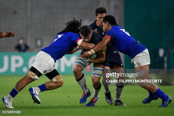 Scotland's flanker Magnus Bradbury is tackled by Samoa's flanker TJ Ioane and Samoa's centre Henry Taefu during the Japan 2019 Rugby World Cup Pool A...