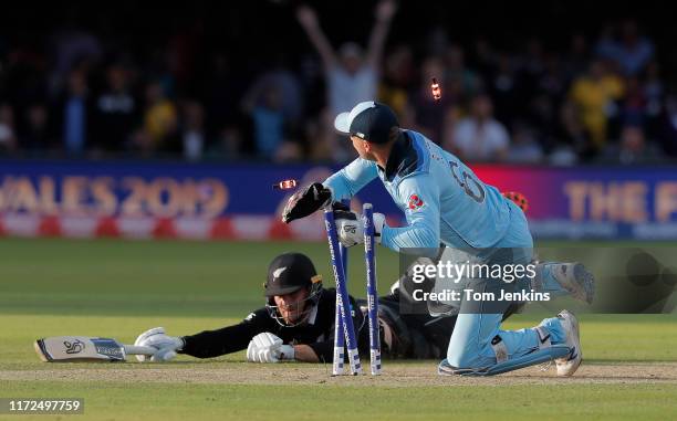 Jos Buttler runs out Martin Guptill off the final ball of the superover to give England victory during the England v New Zealand ICC Cricket World...