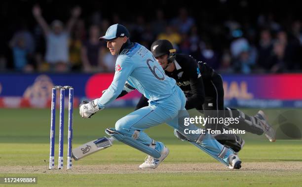 Jos Buttler runs out Martin Guptill off the final ball of the superover to give England victory during the England v New Zealand ICC Cricket World...